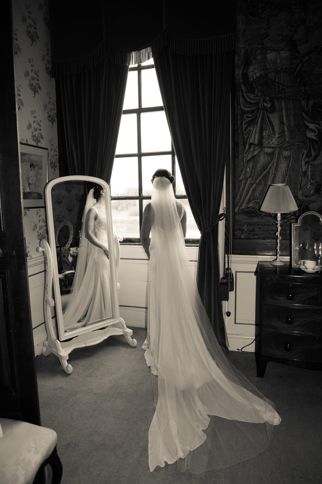 Stanford Hall image of bride stood in window